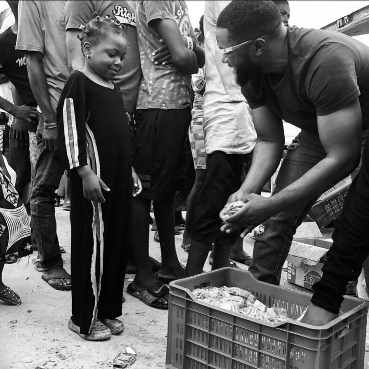 Williams Uchembah gives to a child on the street